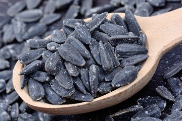 Black sunflower seeds in a spoon