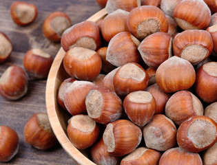 Bowl with hazelnuts on table