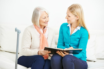 Woman and senior woman with photo album