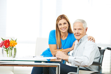 Woman and senior man filling out forms