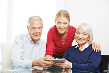 Senior couple using social network on tablet computer