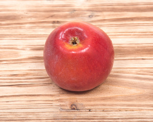 Ripe organic kanzi apple on vintage wooden tray