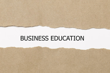 Fototapeta na wymiar business education written under torn paper