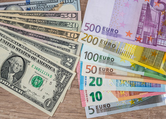Fototapeta na wymiar set of American dollars and set of euros on desk.