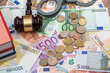 hammer on euro coin and bills.