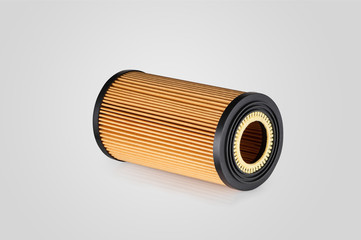 automotive filter cylindrical shape of orange color on a white background with reflection