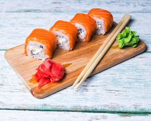 close up of sushi rolls on white tray