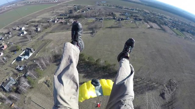 man jumping from antenna with parachute