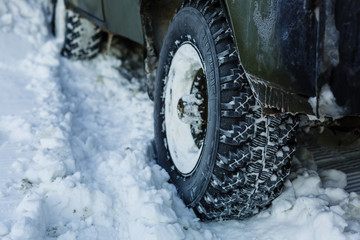 Cropped photo of car covered with snow. Winter tires on .