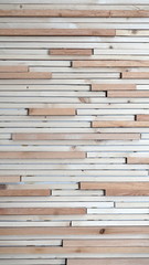 The strips of wood in two colors glued to the wall.
