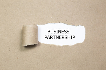 business partnership message written under torn paper.