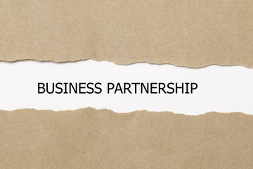 business partnership message written under torn paper.