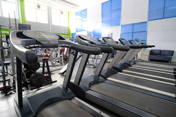 Fototapeta premium Interior of a fitness hall with treadmills