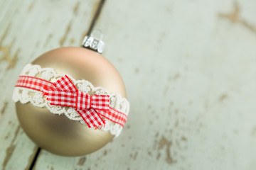 Three Christmas baubles on rustic wood