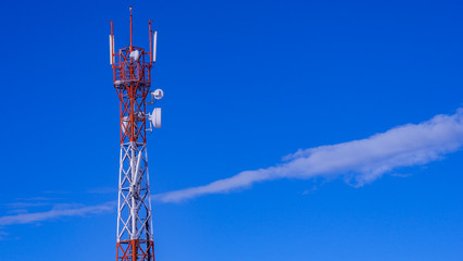 Telecommunication tower with blue sky and cloud in background