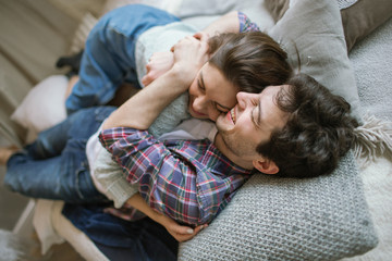 Young hipster couple having fun on handmade bed with dreamcatche