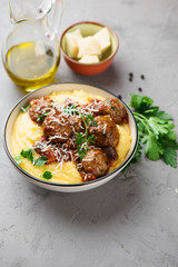 Homemade meatballs in tomato sauce with polenta