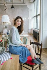 Young beautiful woman on the kitchen in old rustic loft