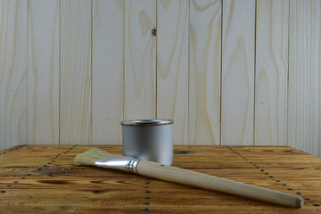 Jar of paint and brush