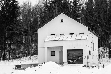 Under construction house of foam blocks. Cottage settlement. Suburb. Private construction. Unfinished city. Winter. Snow. Overcast.