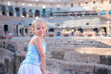 Little girl in Coliseum, Rome, Italy. Back view of kid looking at famous places in Europe