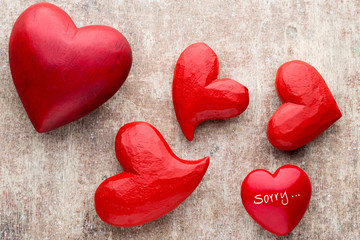 Red heart on the wooden background.