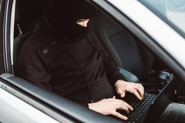 Auto thief trying to break car security systems