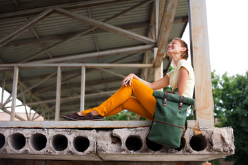 Portrait of Fashion smiling Model Girl on the Industrial Background