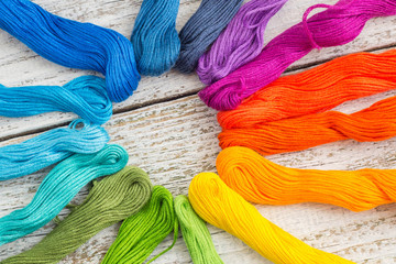 colorful sewing threads for embroidery on white background