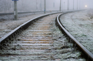 Fototapeta na wymiar Railroad tracks, foggy winter morning.