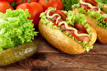 Hotdogs ready-to-eat with fresh salad on wooden desk