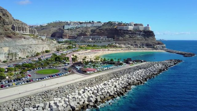 Camera fly over the crowded Amadores beach at Gran Canaria