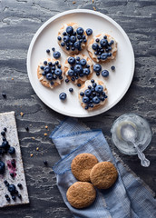 Sweet homemade cookies with fresh berries in white plate top view