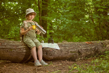 excited child on  camping trip in green forest