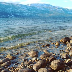 Rolling waves on beach rocks