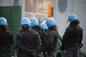 policeman with riot gear  and helmets during the uprising town