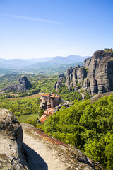 Fototapeta na wymiar Meteora monasteries. Beautiful landscape and view on the Holy Monastery of Roussanov placed on the edge of high rock before sunset. Kastraki, Greece