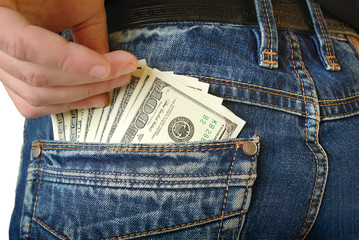 Cash, money is in the pocket of blue jeans