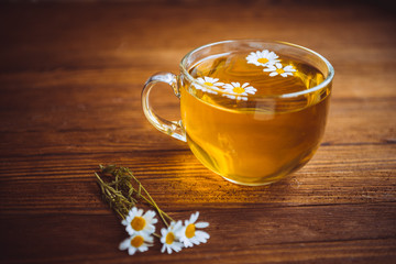 herbal tea cup stands on a brown wooden table