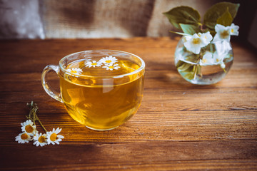 herbal tea cup stands on a brown wooden table