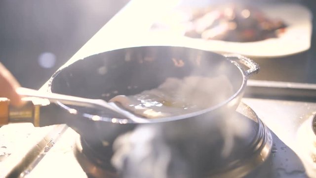 Man overturning omlet in frying pan in 4K