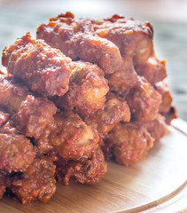 Fried chicken wings on the wooden board