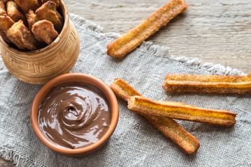 Churros - famous Spanish dessert with chocolate sauce