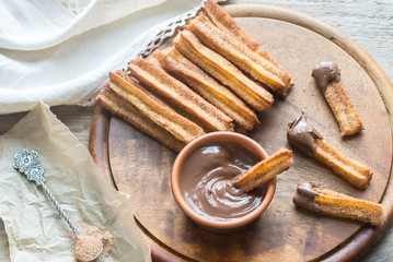 Churros - famous Spanish dessert with chocolate sauce