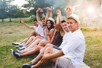 Young people in nature,enjoy,smiling and drinking.Colored photo