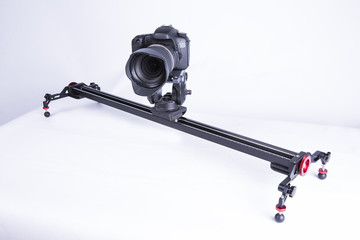 A studio shot of a linear camera slider on a white background.