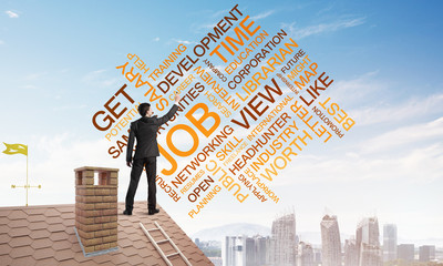Young businessman standing on house roof and writing leadership skill concept. Mixed media
