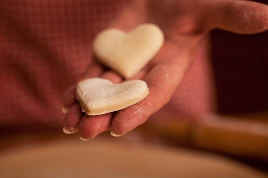 close up of hands  of senior woman preparing delicious cookies