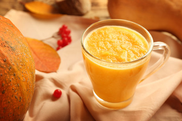 Glass of fresh pumpkin smoothie on napkin