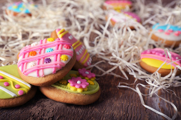 Creative Easter cookies and decorations on wooden table, closeup